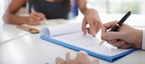 Attorney reviewing a commercial lease agreement with a client during a COVID rent dispute consultation