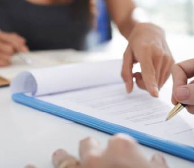 Attorney reviewing a commercial lease agreement with a client during a COVID rent dispute consultation